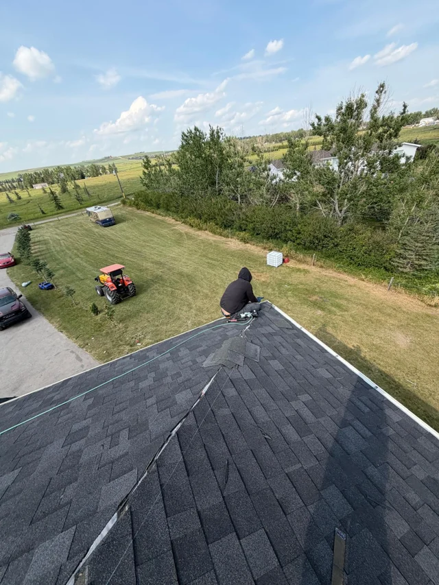 Shingle roof with roofing work in progress