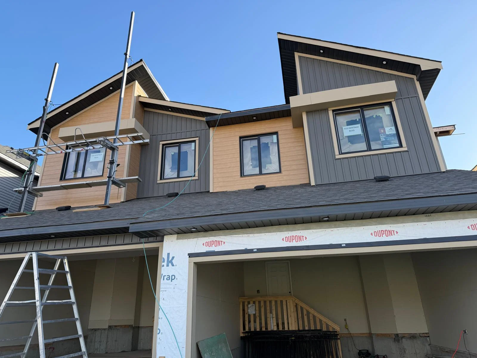 Gable-front exterior with contrasting finishes during construction